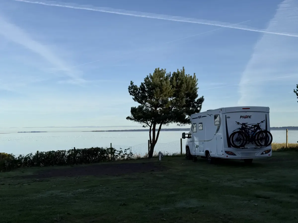 Motorhome with bikes on a panorama pitch overlooking the Limfjord