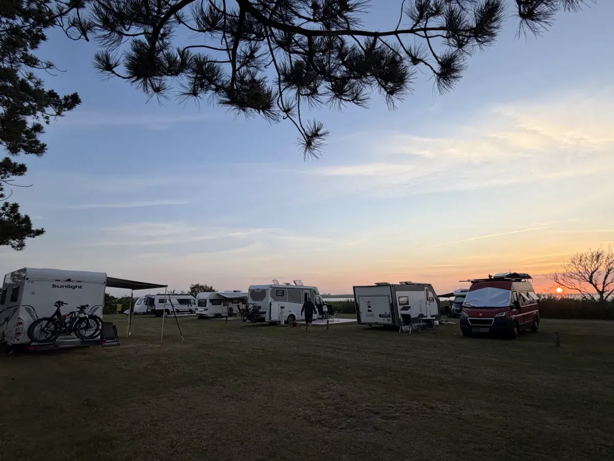 Sunset over the view pitches with motorhomes and bikes